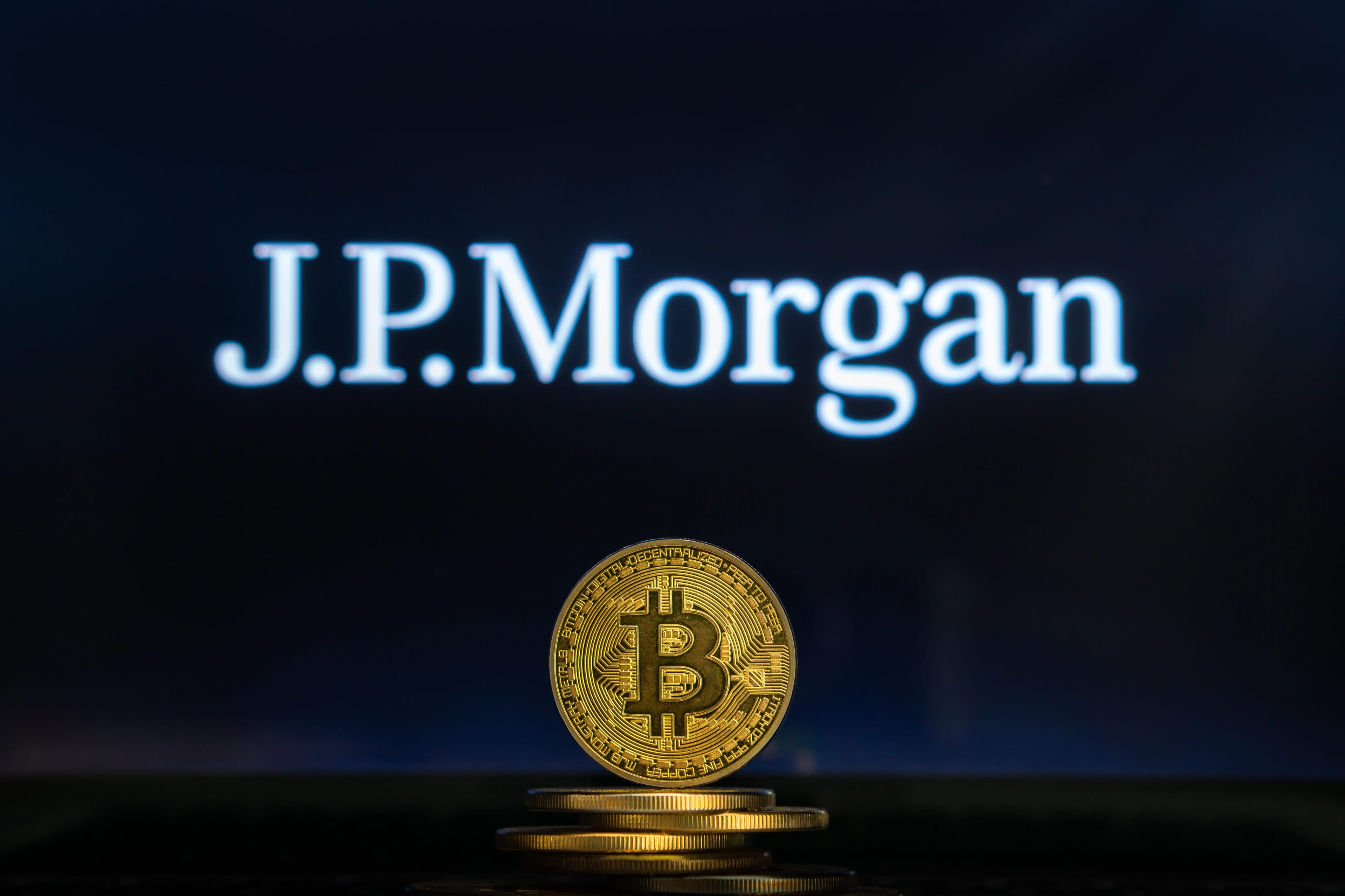 Bitcoin,On,A,Stack,Of,Coins,With,Jpmorgan,Logo,On