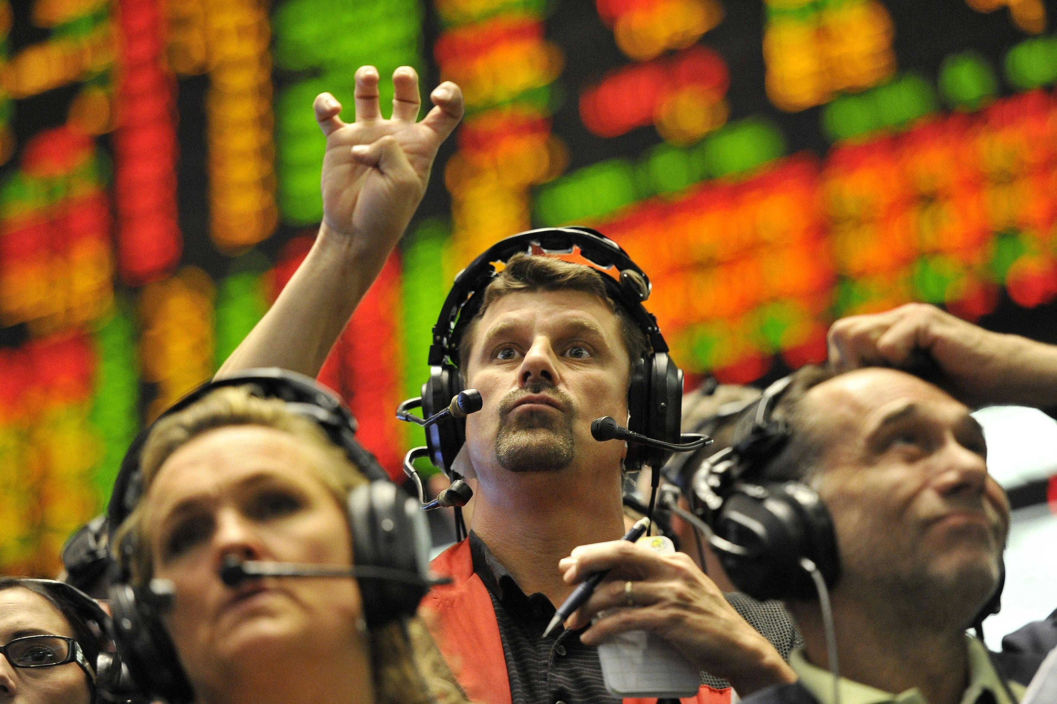 Trader signals at CME Group in Chicago, Illinois, United States - 21 Sep 2011