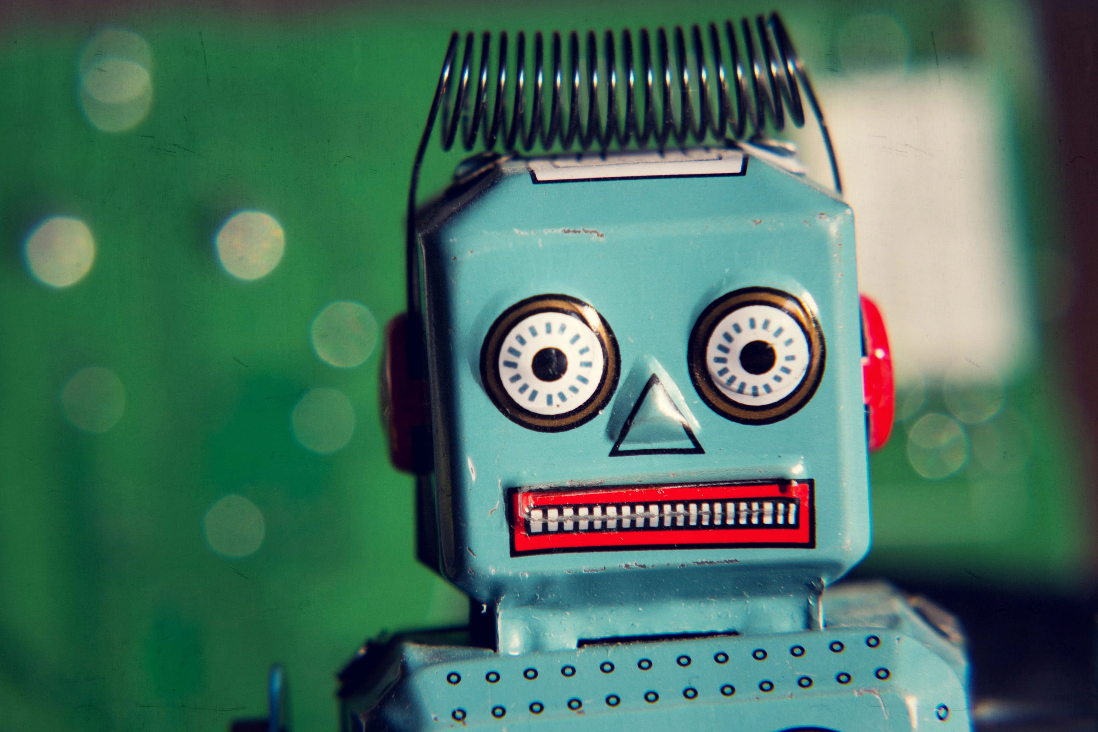 Vintage,Tin,Toy,Robot,With,Green,Computer,Circuit,Board,Background,